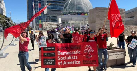 Rallygoers advance in front of San Jose City Hall.