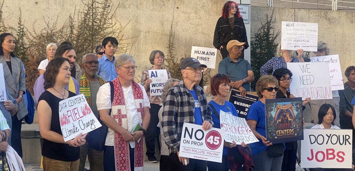 DATA CENTER STANDARDS PROTEST A group of people holding protest signs outside city hall in San Jose, California
