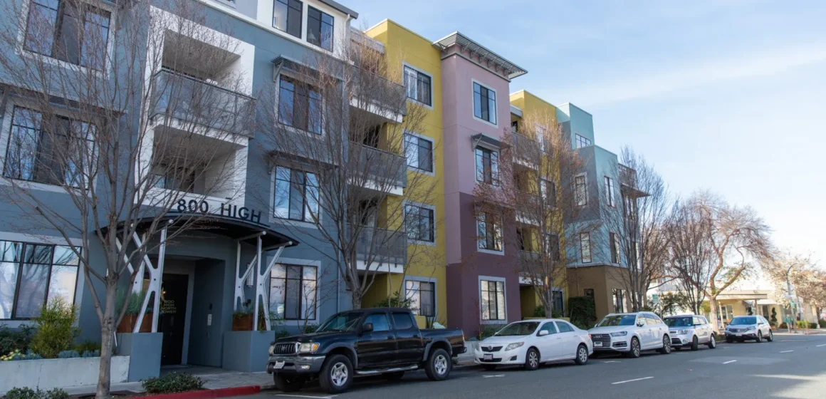 Palo Alto housing audit Embarcadero Cars parked in front of multistory housing building in Palo Alto, California