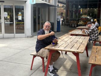 San Jose resident Michael O’Connell Man sitting on a bench by a picnic table