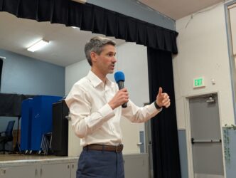 IBM CONSERVATION EASEMENT A man in a white collar shirt holding a microphone