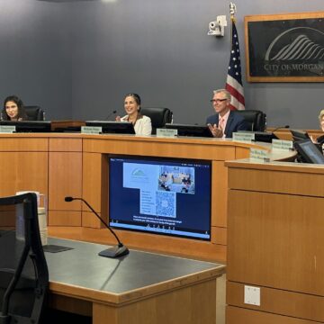 MH 105 HOMES APPROVAL A group of people sitting at a government meeting in Morgan Hill, California