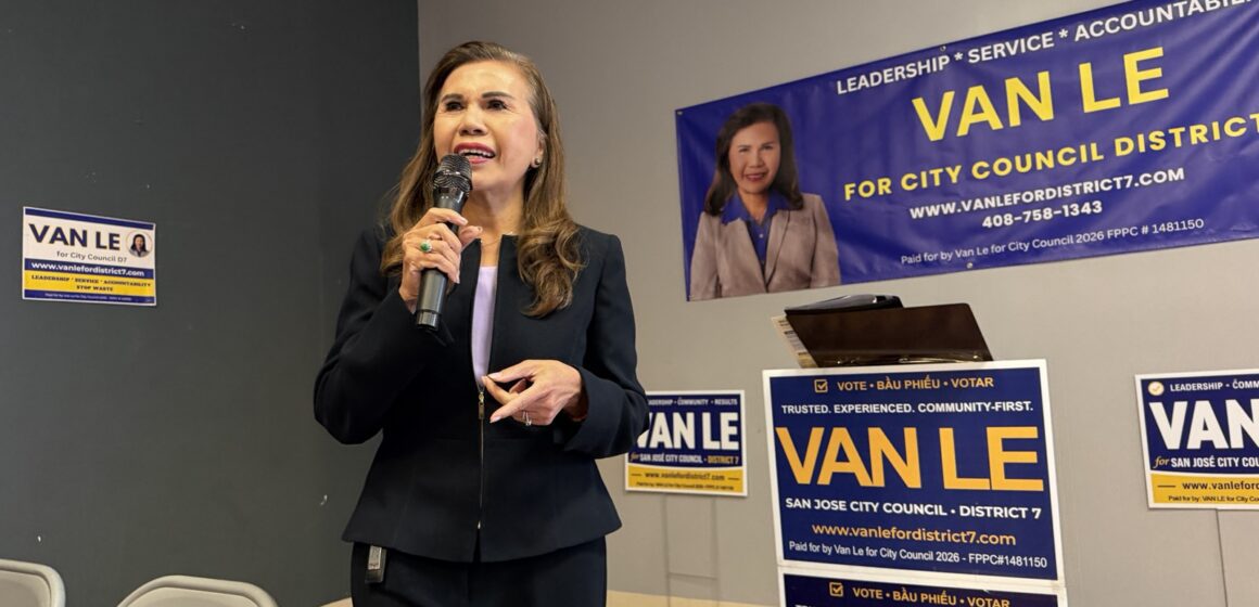 A women speaks at a microphone.