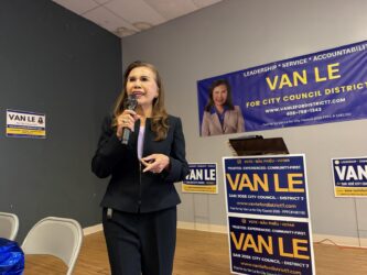 A women speaks at a microphone.