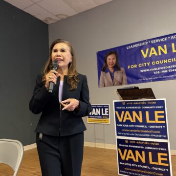Van Le A women speaks at a microphone.