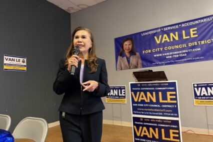A women speaks at a microphone.