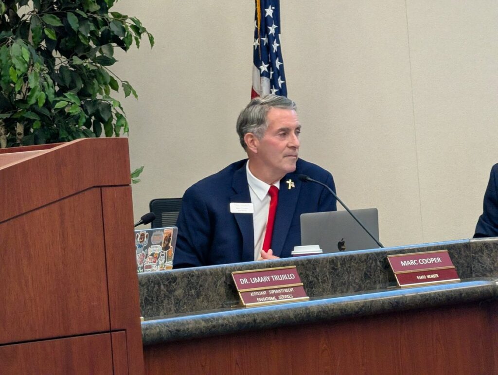 A man sitting at a dais at a school board meeting in San Jose, California