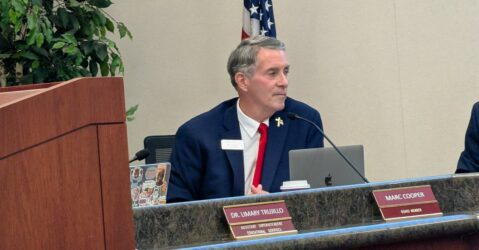 A man sitting at a dais at a school board meeting in San Jose, California